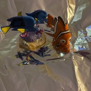 Disney Pixar figure sets featuring Dory parents, Charlie and Jenny/Finding Nemo